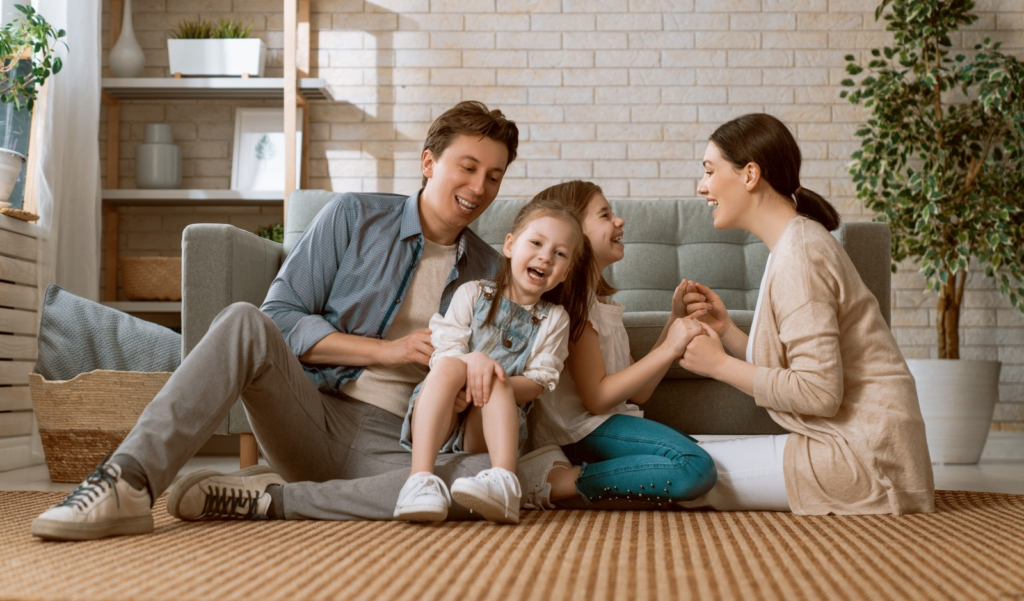 Family Sitting on the Floor Having Fun